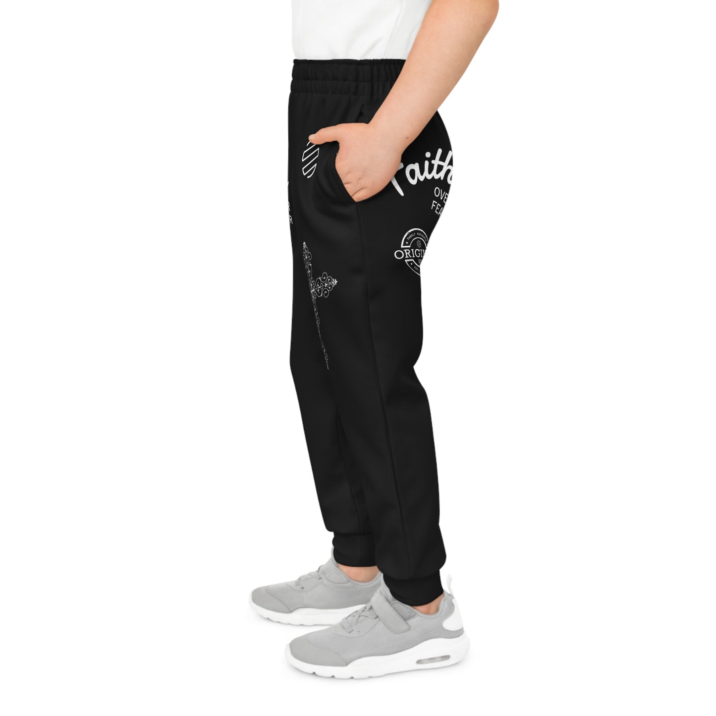 Person wearing black jogger pants with white text and graphics on a white background