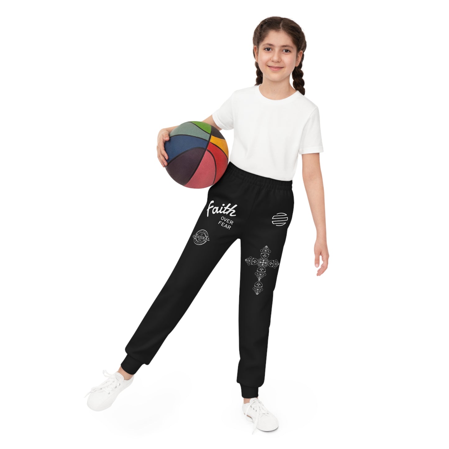 Girl holding a colorful basketball wearing black pants with 'Faith Over Fear' text on a white background