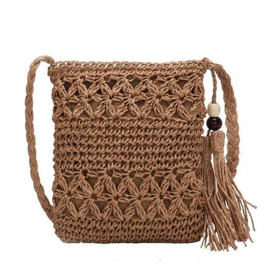 Brown woven handbag with a tassel on a white background