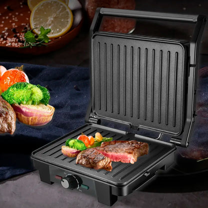 Black portable grill with food on a dark surface